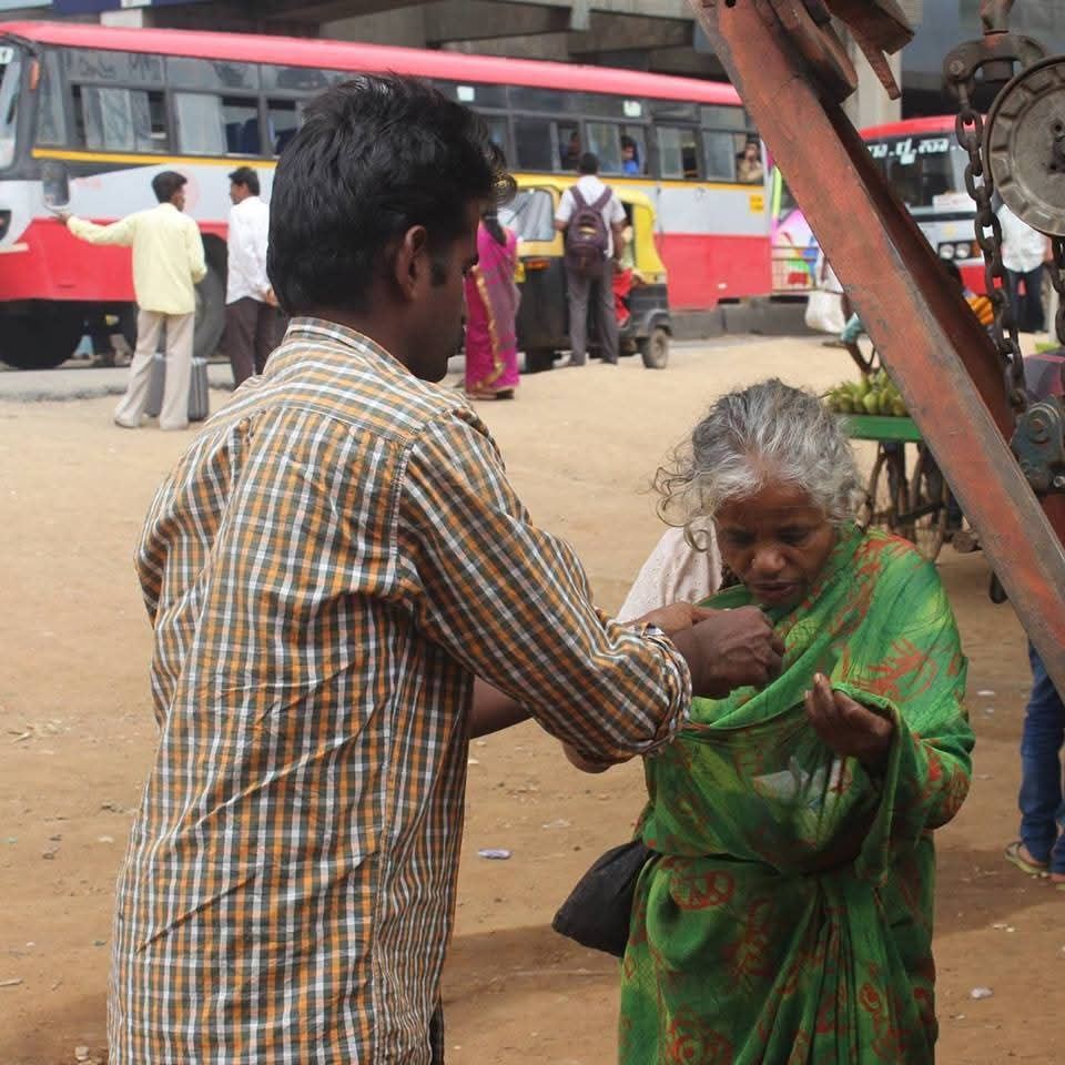 Volunteer helping an elderly woman on the street